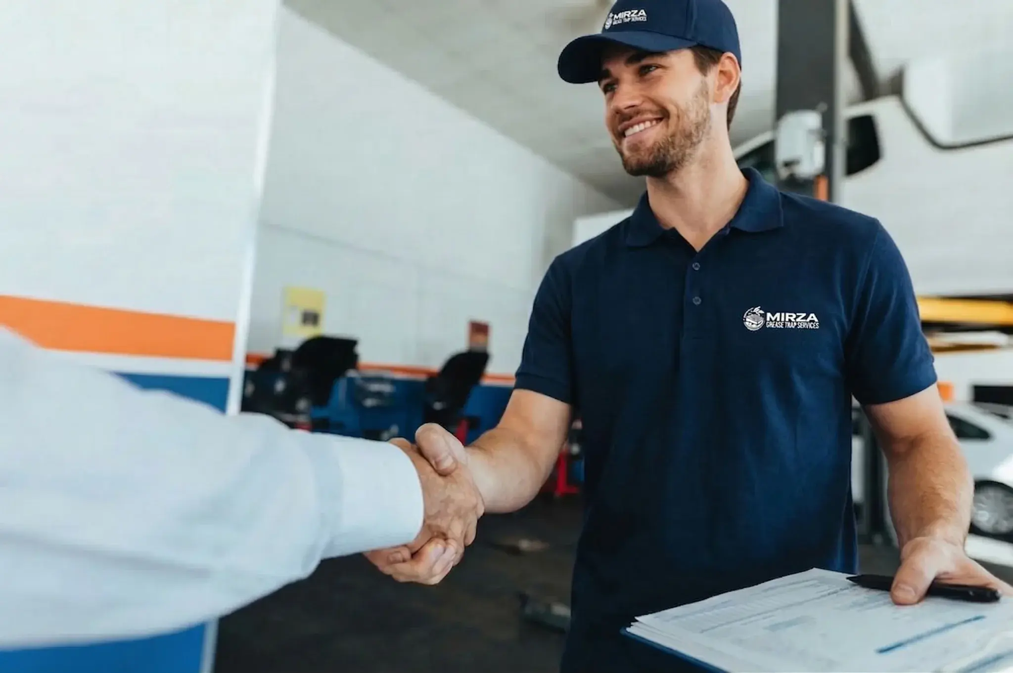 Mirza Grease Trap Services technician greeting a client