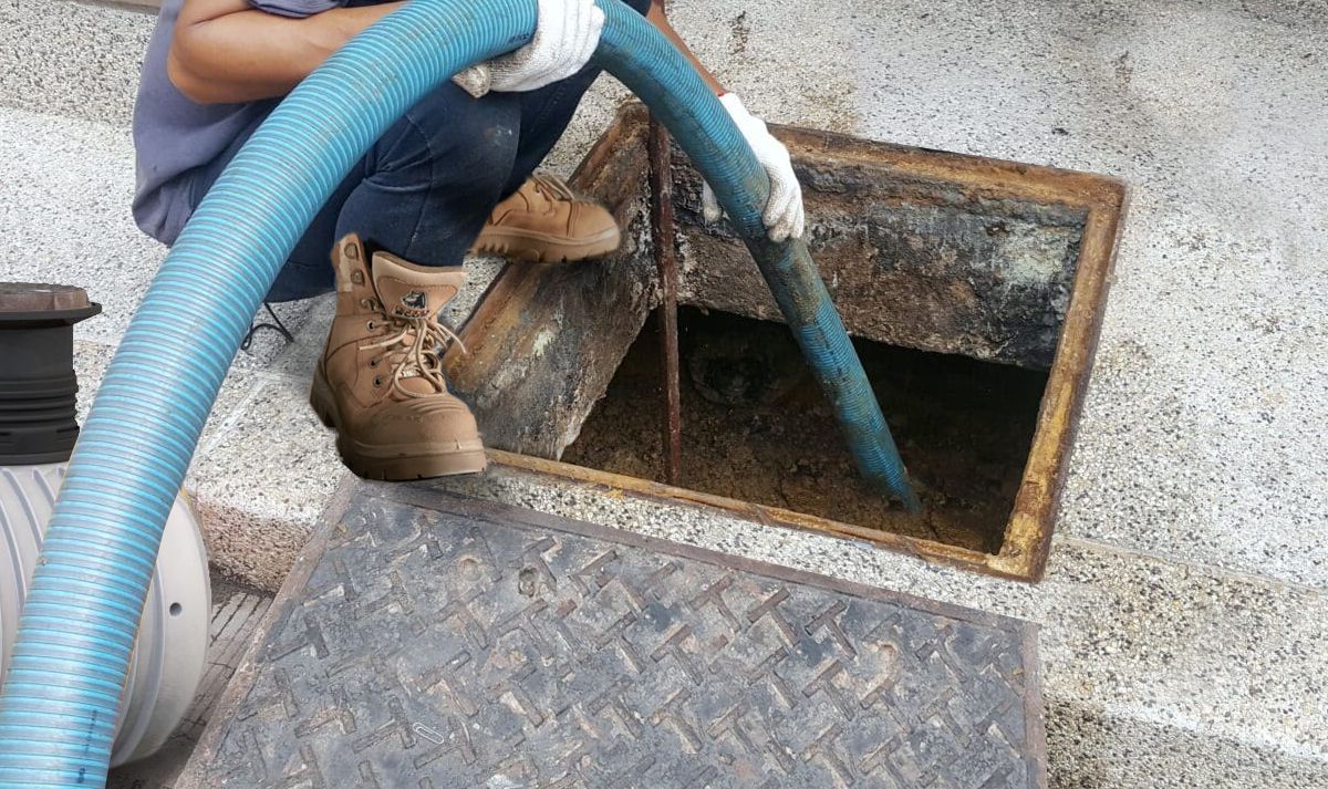 Grease trap cleaning service technician